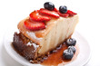 slice of tasty cheesecake with syrup and berries