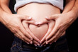 Love hands of pregnant woman and husband