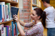 Pretty young woman looking for a book Pretty young woman looking for a book