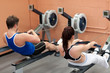 Concentrated people using a rower