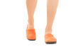 woman walk in bright orange slippers on white background