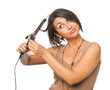 Pretty girl makes styling with hair tongs Pretty girl makes styling with hair tongs