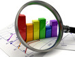Business graphic chart with magnifying glass