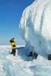 Photographer getting picture of ice cornice on the rock. Photographer getting picture of ice cornice on the rock.