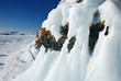 Ice-covered cape rocks of the lake shore with icicles Ice-covered cape rocks of the lake shore with icicles