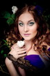Portrait of the red-haired girl in wood