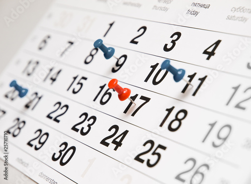 Photo: Closeup calendar page with drawing-pins Closeup calendar page with drawing-pins