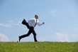 Businessman running in park