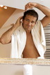 Young man combing his hair