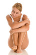 Woman sitting on white background