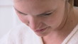 Young woman looking down happily