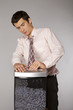 Young caucasian businessman with tie trapped in shredded machine