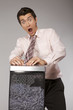 caucasian businessman with tie trapped in shredding machine