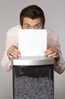 Young caucasian businessman shredding documents