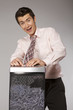 businessman with tie trapped in shredding machine