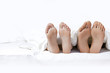 Couple's feet on the bed