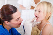 female ENT checking little girls throat