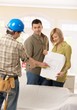 Couple in discussion with builder