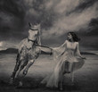 Fine art photo of a young beauty running with a horse