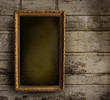 Old frame against a peeling painted wall Old frame against a peeling painted wall