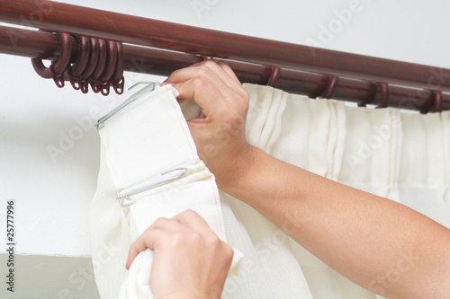 Photo: Hanging up curtain using pleat hooks Hanging up curtain using pleat hooks