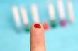 Diabetic is doing a glucose level finger blood test