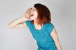 young redhead woman calling someone, hand near lips, side view, young redhead woman calling someone, hand near lips, side view,