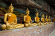 Buddha on stone babkground in cave of Thailand