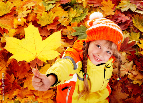 Photo: Child in autumn orange leaves. Child in autumn orange leaves.