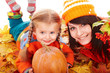 Happy family with pumpkin on autumn leaves. Happy family with pumpkin on autumn leaves.
