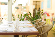 Tableware on table with series chairs. Tableware on table with series chairs.