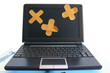 laptop computer with bandages - computer repair, or healthcare