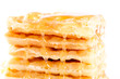 Closeup of pile of waffles with honey