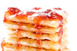 Closeup of pile of waffles with honey, strawberry jam and sugar