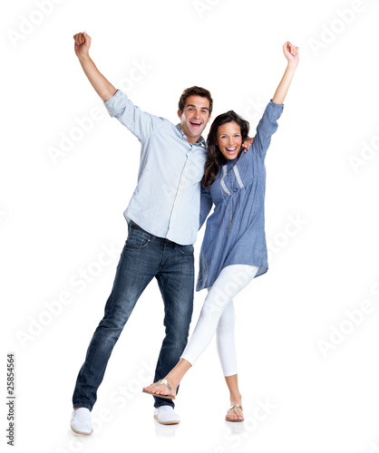 Photo: Young couple celebrating success with hands raised Young couple celebrating success with hands raised