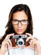 An attractive young lady holding a camera on white An attractive young lady holding a camera on white
