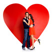 Image : Romantic young couple embracing against red heart
