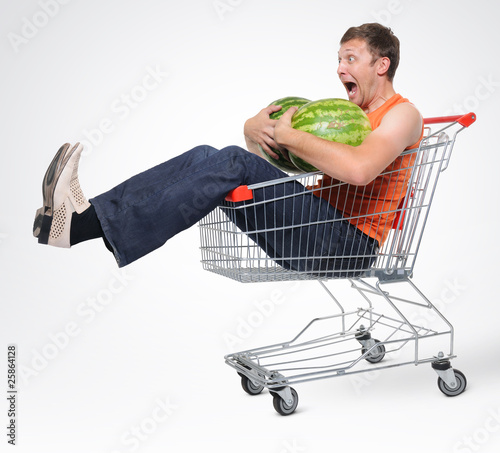 Photo: Crazy man in shopping-cart with two watermelon Crazy man in shopping-cart with two watermelon