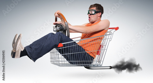 Photo: Unreal crazy driver in a shopping-cart with wheel Unreal crazy driver in a shopping-cart with wheel