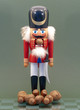 Wooden Nutcracker with Nuts Isolated on a Green Background.