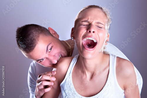 Photo: Wild boy bite women shoulder, woman screeming Wild boy bite women shoulder, woman screeming