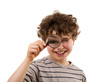 Boy looking through magnifying glass isolated on white Boy looking through magnifying glass isolated on white