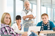 High school - three students with mature professor High school - three students with mature professor