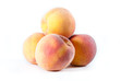 Pile of fresh peaches on a white isolated background