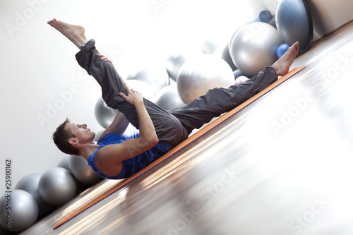 Photo: fusion of mind and body - man practicing pilates fusion of mind and body - man practicing pilates