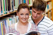 Young caucasian couple reading a book Young caucasian couple reading a book
