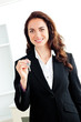 Portrait of a caucasian businesswoman holding a key