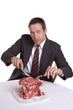 Man looking with pile of steaks