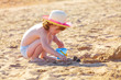 Cute baby girl playing with toys on a beach Cute baby girl playing with toys on a beach