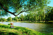 happy girl sitting on river bank happy girl sitting on river bank